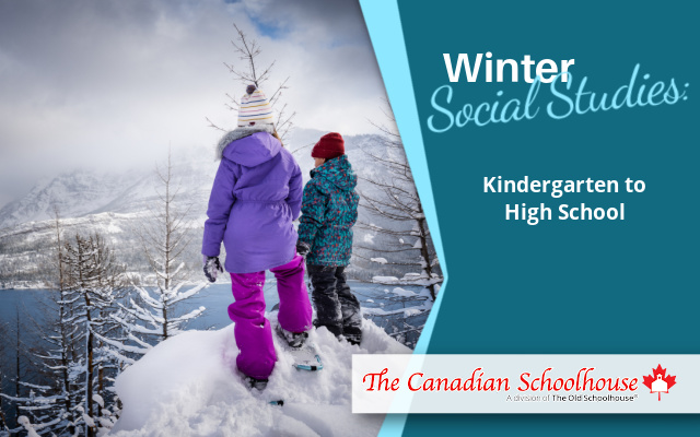 two kids standing at a peak in the winter snow